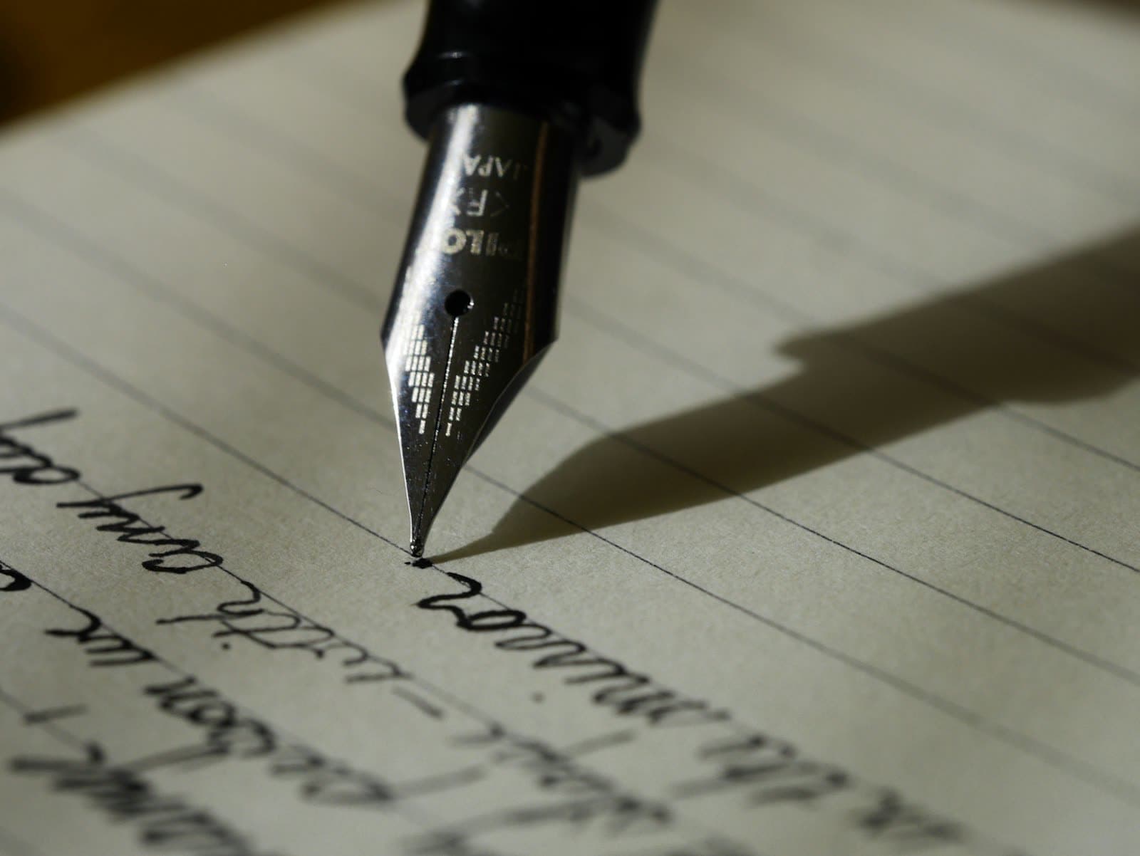 Open journal with a pen on a wooden desk