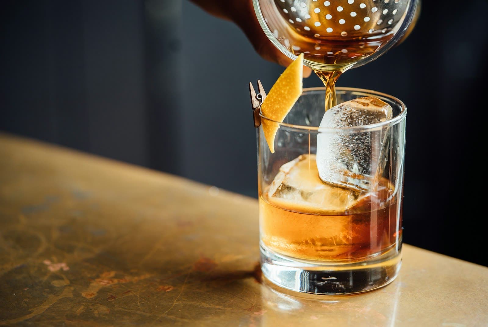 Short cut-glass tumblers on a dark bar